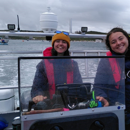 Emma is standing aboard a boat with Project Seagrass' Skipper Eve